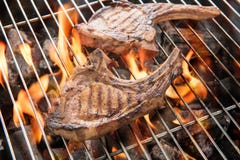 Grilled Pork Steaks Over Flames On The Grill. Stock Image Grilled Pork Steaks Over Flames On The Grill. Stock Image
