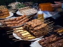 Grilled pork top cheese with sweet sauce, Thai style sausage on plate in street food stock photo Grilled pork top cheese with sweet sauce, Thai style sausage on plate in street food stock photo
