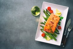 Grilled salmon garnished with green asparagus and tomatoes stock photos Grilled salmon garnished with green asparagus and tomatoes stock photos