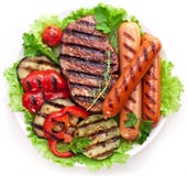 Grilled steak,sausages and vegetables. stock images Grilled steak,sausages and vegetables. stock images