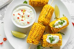 Grilled sweet corn with white mexican sauce, chilli and lime. healthy summer food stock photography Grilled sweet corn with white mexican sauce, chilli and lime. healthy summer food stock photography