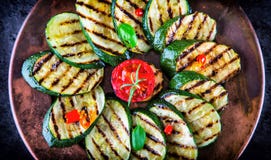 Grilled Zucchini Tomato with chili pepper. Italian mediterranean or greek cuisine. Vegan vegetarian food stock images Grilled Zucchini Tomato with chili pepper. Italian mediterranean or greek cuisine. Vegan vegetarian food stock images