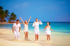 Groep gelukkige opgewekte vrienden die pret op tropisch strand hebben, de zomervakantie royalty-vrije stock afbeeldingen Groep gelukkige opgewekte vrienden die pret op tropisch strand hebben, de zomervakantie royalty-vrije stock afbeeldingen
