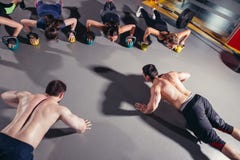Groep sportieve mensen die in een gymnastiek opleiden stock afbeeldingen Groep sportieve mensen die in een gymnastiek opleiden stock afbeeldingen