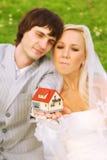 Groom and bride keep small house on hands Royalty Free Stock Image Groom and bride keep small house on hands Royalty Free Stock Image