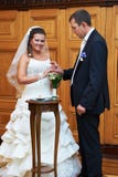 Groom wears a wedding ring a happy bride stock photo Groom wears a wedding ring a happy bride stock photo