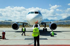 Ground Crew Guides A Jet To The Gate Royalty Free Stock Images