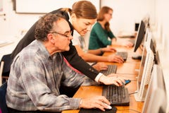Group of adults learning computer skills. Intergenerational tran stock photography Group of adults learning computer skills. Intergenerational tran stock photography
