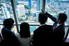 Group of Asian businesspeople looking at city skyline royalty free stock photo Group of Asian businesspeople looking at city skyline royalty free stock photo