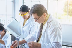 Group of asian scientist working and explaining research information together in the laboratary stock photo Group of asian scientist working and explaining research information together in the laboratary stock photo