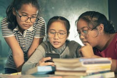 Group of asian teenager reading message on smart phone Stock Images Group of asian teenager reading message on smart phone Stock Images