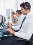 Group of call center employees working in line Royalty Free Stock Image Group of call center employees working in line Royalty Free Stock Image