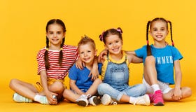 Group of cheerful happy children on colored yellow background royalty free stock images Group of cheerful happy children on colored yellow background royalty free stock images