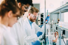Group of chemistry students working in laboratory stock photos Group of chemistry students working in laboratory stock photos