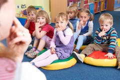 Group Of Children Copying Teacher In Montessori/Pre-School Class royalty free stock photo Group Of Children Copying Teacher In Montessori/Pre-School Class royalty free stock photo
