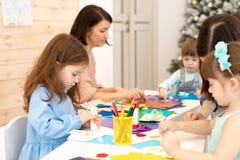 Group of children at daycare. Preschool children working with color paper, sciccors and glue on art class in royalty free stock image Group of children at daycare. Preschool children working with color paper, sciccors and glue on art class in royalty free stock image
