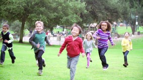 Group Of Children Running Towards Camera In Slow Motion