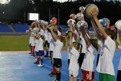 A group of children at the stadium holds a raised ball in their hand, Puławy, 05.2012, Poland stock image A group of children at the stadium holds a raised ball in their hand, Puławy, 05.2012, Poland stock image