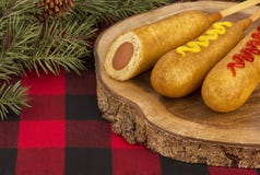 Group of corn dogs on a wooden plank. Fast food restaurant. royalty free stock images Group of corn dogs on a wooden plank. Fast food restaurant. royalty free stock images