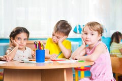 Group of cute little prescool kids drawing stock images Group of cute little prescool kids drawing stock images
