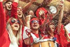 Group of fans dressed in red color watching a sports event Royalty Free Stock Photography Group of fans dressed in red color watching a sports event Royalty Free Stock Photography