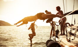 Group of friends diving in the water during a boat excursion royalty free stock image Group of friends diving in the water during a boat excursion royalty free stock image