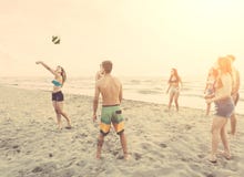 Group of friends playing with ball on the beach stock photos Group of friends playing with ball on the beach stock photos