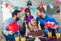 Group of happy friends celebrating birthday at home and having fun stock photography Group of happy friends celebrating birthday at home and having fun stock photography