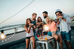 Group of happy friends having party on rooftop stock images Group of happy friends having party on rooftop stock images