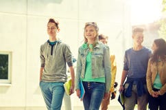 Group of happy teenage students walking outdoors royalty free stock photos Group of happy teenage students walking outdoors royalty free stock photos
