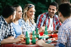 Group of happy people eating food outdoors stock image Group of happy people eating food outdoors stock image