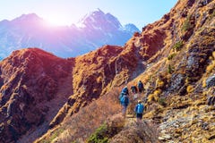 Group of Hikers walking on Mountain Trail rear View sunny Background royalty free stock photos Group of Hikers walking on Mountain Trail rear View sunny Background royalty free stock photos
