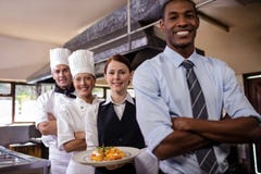 Group of hotel staffs standing with armas crossed in kitchen royalty free stock photos Group of hotel staffs standing with armas crossed in kitchen royalty free stock photos