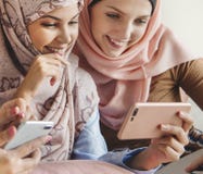 Group of islamic women talking and watching on the phone together stock photos Group of islamic women talking and watching on the phone together stock photos