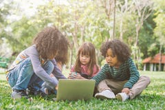 Group of kids with laptop. happy children in nature with group of friend. stock images Group of kids with laptop. happy children in nature with group of friend. stock images