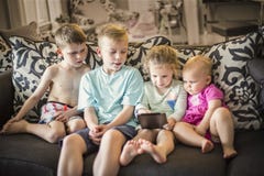 Group of kids playing with an electronic tablet devices stock image Group of kids playing with an electronic tablet devices stock image