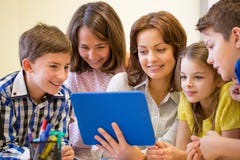 Group of kids with teacher and tablet pc at school royalty free stock photography Group of kids with teacher and tablet pc at school royalty free stock photography