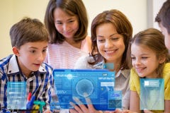 Group of kids with teacher and tablet pc at school stock image Group of kids with teacher and tablet pc at school stock image