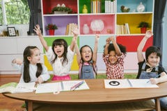 Group of little preschool kids hands up in class . portrait of children diversity education concept. stock photo Group of little preschool kids hands up in class . portrait of children diversity education concept. stock photo