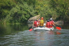 Group of men and women, enjoy water rafting activity at river. stock image Group of men and women, enjoy water rafting activity at river. stock image