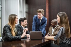 Group of multiethnic busy people working in an office stock photos Group of multiethnic busy people working in an office stock photos