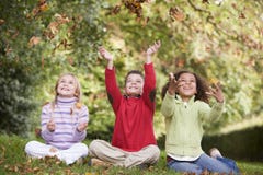 Group Of Children Playing In Autumn Leaves Stock Image Group Of Children Playing In Autumn Leaves Stock Image