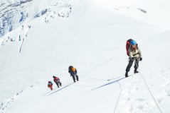Group Of Climbers Reaches The Top Of Mountain Peak. Climbing And Stock Image