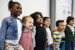 Group Of Diverse Kindergarten Students Standing Together In Classroom Royalty Free Stock Photography Group Of Diverse Kindergarten Students Standing Together In Classroom Royalty Free Stock Photography