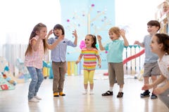 Group Of Happy Children Jump In Club. Kids Playing Together Stock Images