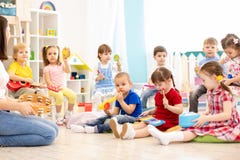 Group Of Kindergarten Children Play With Musical Toys. Early Musical Education In Daycare Royalty Free Stock Photography Group Of Kindergarten Children Play With Musical Toys. Early Musical Education In Daycare Royalty Free Stock Photography