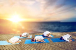 Group of people doing yoga child pose outdoors Royalty Free Stock Image Group of people doing yoga child pose outdoors Royalty Free Stock Image