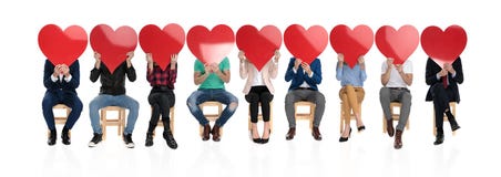 Group of people holding big red hearts over their faces royalty free stock photo Group of people holding big red hearts over their faces royalty free stock photo