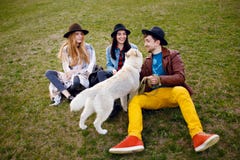 A group of people sitting on the green grass. They laugh and smile. Friendly atmosphere on nature background. stock images A group of people sitting on the green grass. They laugh and smile. Friendly atmosphere on nature background. stock images