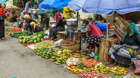 Group of poor women selling vegetables and fruits on a street Stock Photography Group of poor women selling vegetables and fruits on a street Stock Photography